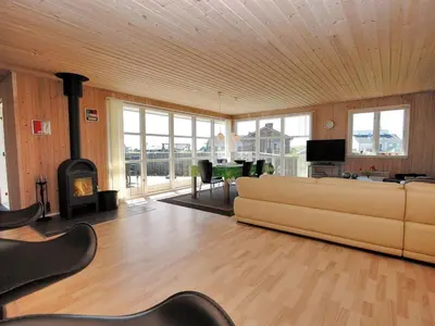 a living room with a couch and a fireplace at Holiday Home Ernbiorn - from the sea by Interhome in Harboør