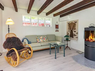 a living room with a couch and a fireplace at 4 person holiday home in Højslev-By Traum in Højslev