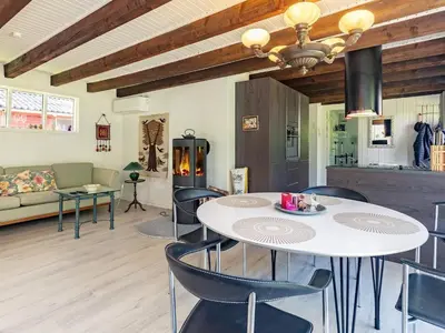 a living room with a table and chairs and a couch at 4 person holiday home in Højslev-By Traum in Højslev