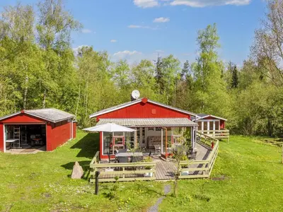 a red barn with a porch and a patio at 4 person holiday home in Højslev-By Traum in Højslev