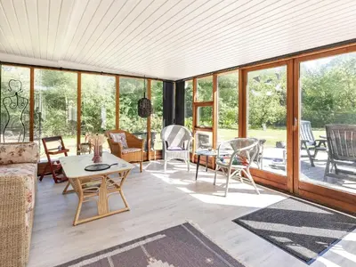 a screened in porch with furniture and windows at 4 person holiday home in Højslev-By Traum in Højslev