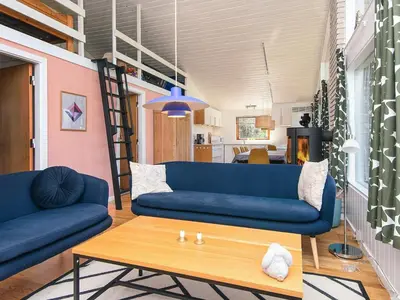 a living room with a blue couch and a table at 7 person holiday home in Skals-By Traum in Skals