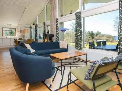 a living room with blue couches and chairs at 7 person holiday home in Skals-By Traum in Skals