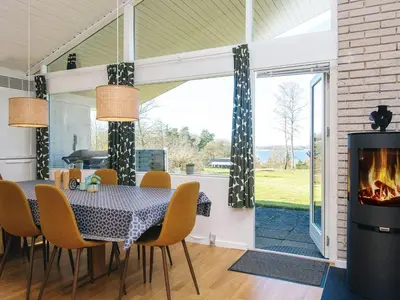 a dining room with a table and a fireplace at 7 person holiday home in Skals-By Traum in Skals