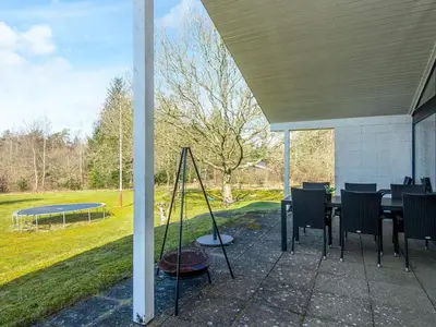a patio with a table and chairs and a ping pong at 7 person holiday home in Skals-By Traum in Skals