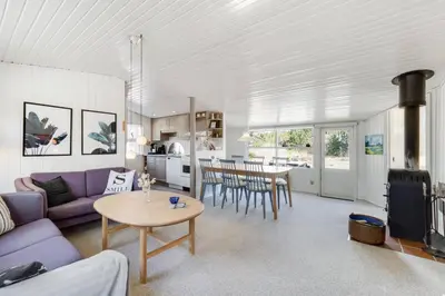 a living room with a purple couch and a table at Cozy Holiday Home in Lovely Surroundings in Sønder Vorupør