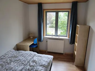 a bedroom with a bed and a window and a desk at Hjortdal B&B in Fjerritslev