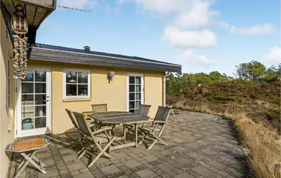 a patio with a table and chairs in front of a house at Awesome Home In Fjerritslev With Wifi in Fjerritslev