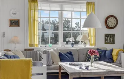 a living room with a couch and a table at Awesome Home In Fjerritslev With Wifi in Fjerritslev