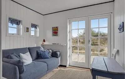 a living room with a couch and a glass door at Awesome Home In Fjerritslev With Wifi in Fjerritslev
