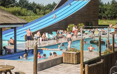 a group of people in a swimming pool with a slide at 2 Bedroom Stunning Home In Hanstholm in Hanstholm