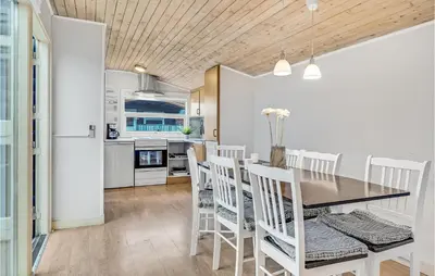 a kitchen and dining room with a table and chairs at 2 Bedroom Stunning Home In Hanstholm in Hanstholm