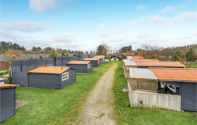 a row of tiny houses on a grass field at 2 Bedroom Stunning Home In Hanstholm in Hanstholm