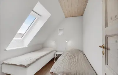 a bedroom with two beds and a window at 3 Bedroom Cozy Home In Vesløs in Vesløs