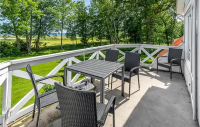 a patio with chairs and a table on a balcony at 3 Bedroom Cozy Home In Vesløs in Vesløs