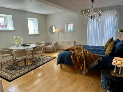 a bedroom with a bed and a table and chairs at Skuespiller Centralen in Viborg