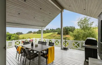 a patio with a table and chairs on a deck at Nice Home In Fur With Sauna in Furland