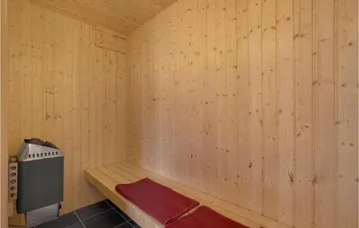 a sauna with a bench and a heater in it at Nice Home In Fur With Sauna in Furland