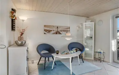 a dining room with two chairs and a table at Lovely Home In Pandrup With Wifi in Pandrup