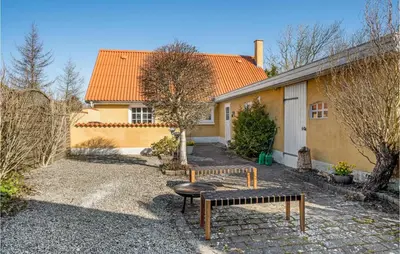 a house with a bench in front of it at Lovely Home In Pandrup With Wifi in Pandrup
