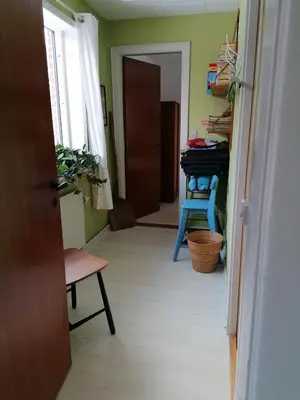 a hallway with a room with a piano and a chair at B&B Tvolm Ydby Thy in Tvolm