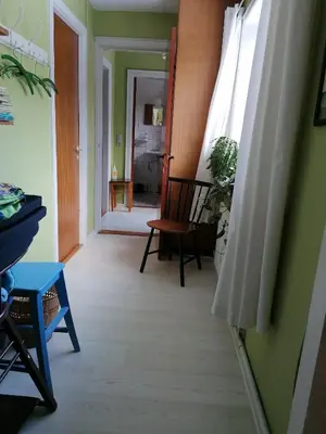 a room with a hallway with a chair and a window at B&B Tvolm Ydby Thy in Tvolm