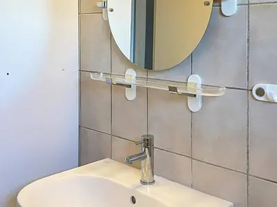 a bathroom with a sink and a mirror on the wall at 4 person holiday home in Frøstrup in Frøstrup