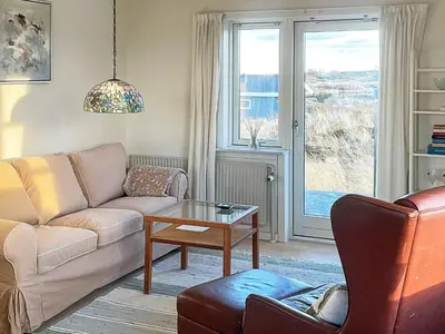 a living room with a couch and a table at 4 person holiday home in Frøstrup in Frøstrup