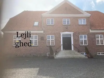 a red brick house with a left eyed sign on it at Store Sand in Vemb