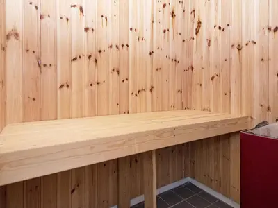 a wooden paneled wall with a bench in a sauna at 6 person holiday home in Vemb-By Traum in Vemb