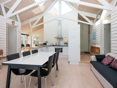a dining room and kitchen with a table and chairs at 6 person holiday home in Vemb-By Traum in Vemb