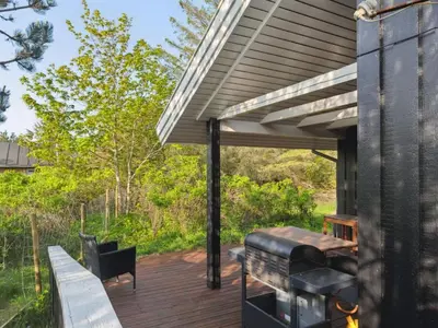 a wooden deck with a pergola and a grill at Holiday Home Gottliebe - 850m from the sea by Interhome in Torsted