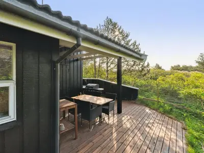 a patio with a table and chairs on a deck at Holiday Home Gottliebe - 850m from the sea by Interhome in Torsted