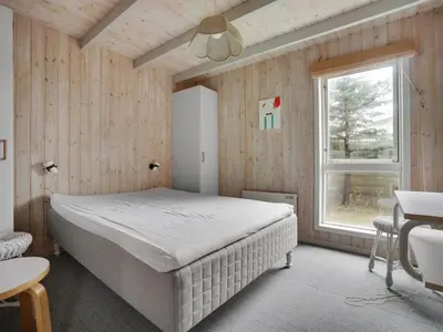 a bedroom with a large bed and a window at Holiday Home Gottliebe - 850m from the sea by Interhome in Torsted