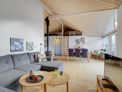 a living room with a couch and a table at Holiday Home Daina - 400m to the fjord by Interhome in Vemb