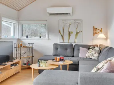 a living room with a couch and a tv at Holiday Home Daina - 400m to the fjord by Interhome in Vemb