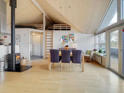 a kitchen and dining room with a table and chairs at Holiday Home Daina - 400m to the fjord by Interhome in Vemb