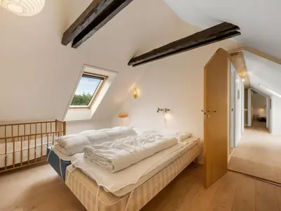 a bedroom with a large bed and a window at Holiday Home Wilmar - 1km to the fjord by Interhome in Vemb