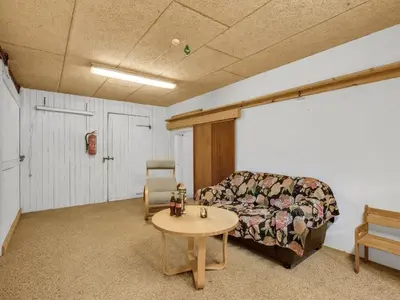 a living room with a couch and a table at Holiday Home Wilmar - 1km to the fjord by Interhome in Vemb