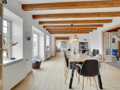 a dining room with a long table and chairs at Holiday Home Thorge - 75m to the fjord by Interhome in Struer
