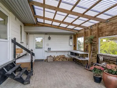 a barn conversion with a skylight roof and a patio at Holiday Home Tomine - 500m to the fjord by Interhome in Struer