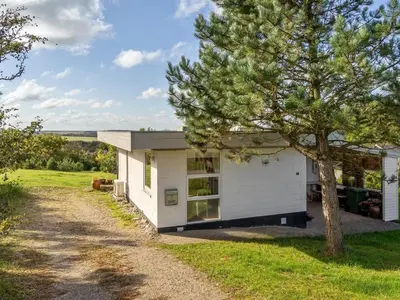 a white house with a tree in front of it at Holiday Home Tomine - 500m to the fjord by Interhome in Struer
