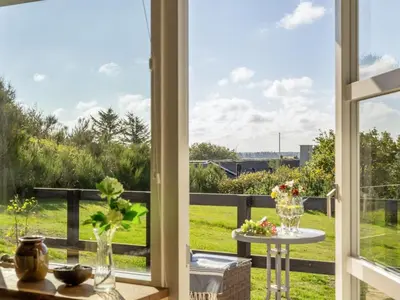 a room with a window looking out at a yard at Holiday Home Tomine - 500m to the fjord by Interhome in Struer