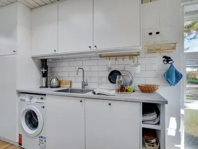 a white kitchen with a sink and a dishwasher at Holiday Home Tomine - 500m to the fjord by Interhome in Struer