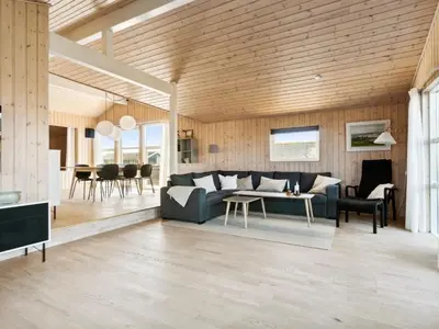 a living room with a couch and a table at Holiday Home Marissa - 200m from the sea by Interhome in Torsted