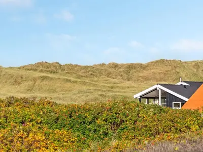 a house with an orange roof on a hill at Holiday Home Marissa - 200m from the sea by Interhome in Torsted