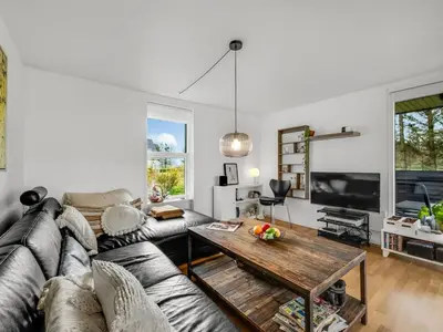 a living room with a couch and a table at Holiday Home Aleida - 100m to the fjord by Interhome in Vemb