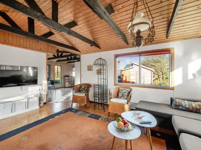 a living room with a couch and a tv at Holiday Home Alpi - 250m to the fjord by Interhome in Struer