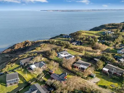 an aerial view of a house on a hill next to the water at Holiday Home Alpi - 250m to the fjord by Interhome in Struer