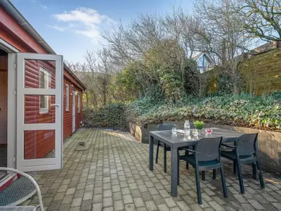 a patio with a table and chairs and a door at Holiday Home Alpi - 250m to the fjord by Interhome in Struer